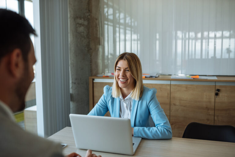 Woman on Laptop Collaborating With Colleagues