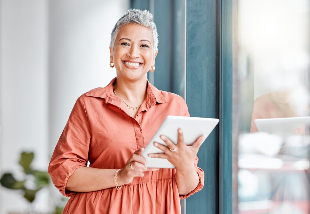 Portrait of Senior Business Woman In Office with tablet
