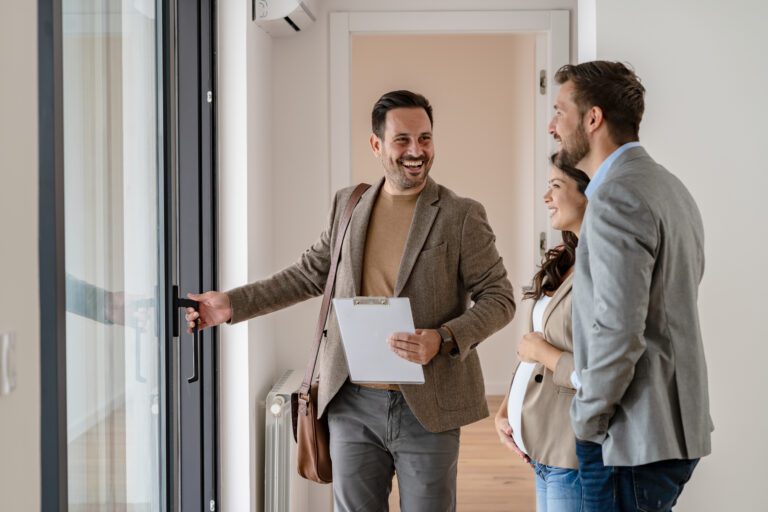 A Young Couple With A Real Estate Agent Visiting An Apartment