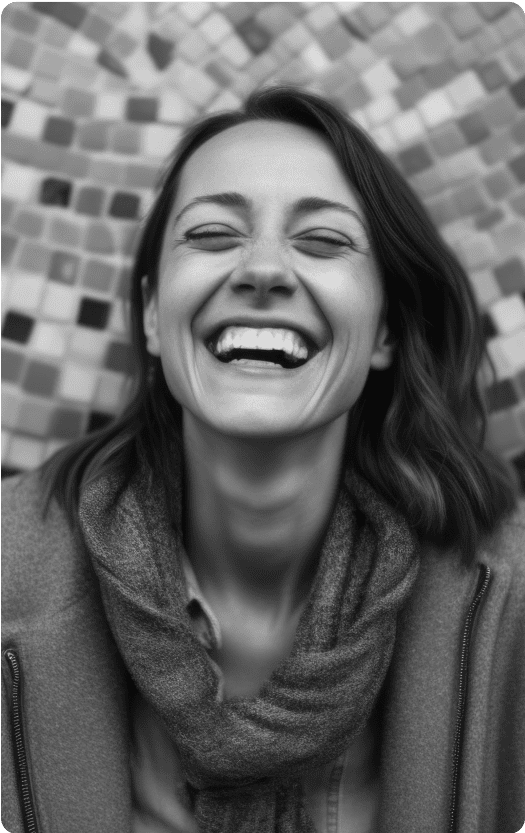 Young smiling woman against a mosaic background.