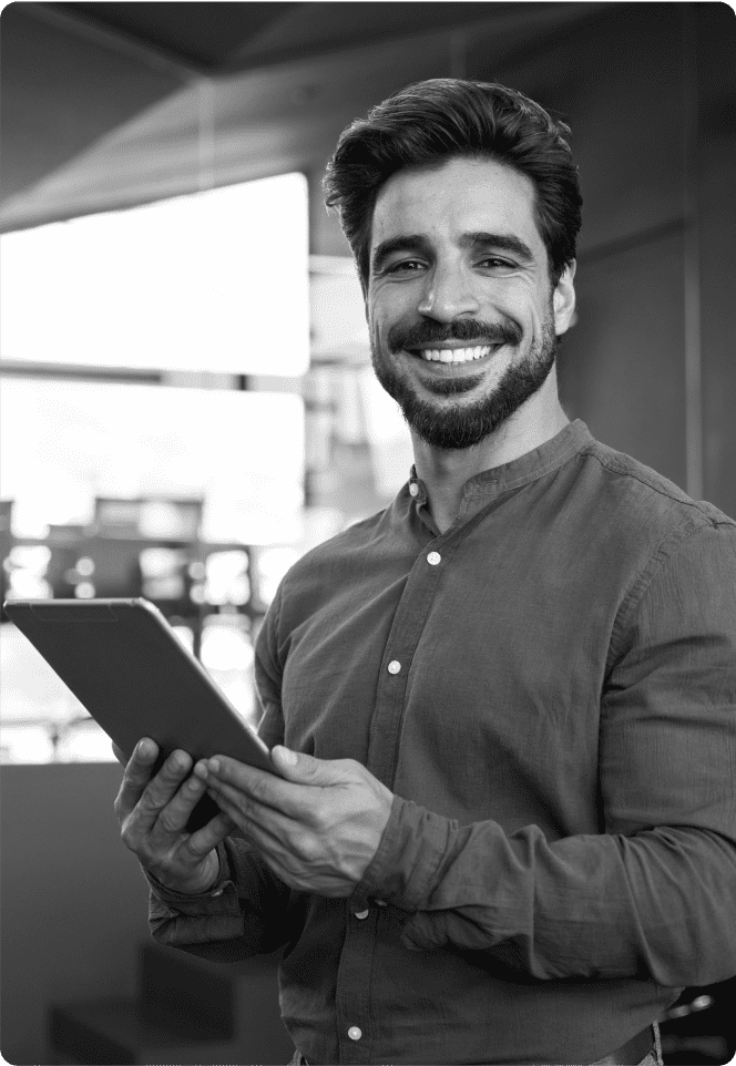 Young bearded man holds a tablet in a restaurant setting
